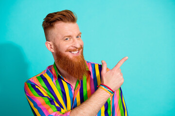 Portrait of cheerful guy with red hair beard and mustache direct forefinger empty space news...