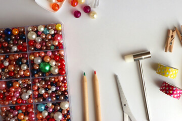 Various craft supplies on white background. Supplies for jewelry making, drawing and needlework....