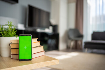 Digital detox concept. In the foreground is a smartphone with green chroma key screen