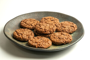 chocolate cookies on a dish isolated on a white background