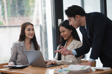 Young smart manager giving his advice to the business team in the meeting room.