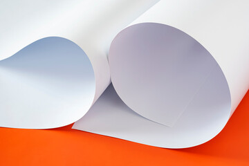 Sheets of white paper on an orange background.