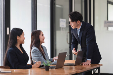 Handsome Asian businessman presenting his idea to his teammate in the meeting room.