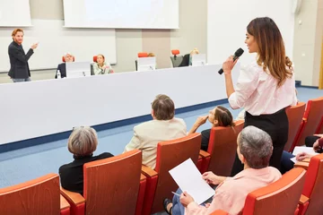 Washable wall murals Height scale Audience asking question to orator at business conference in auditorium