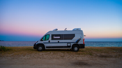 Fototapeta na wymiar Campervan or motorhome parked on the beach in Greece.