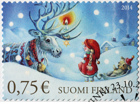 Girl and reindeer in a finnish christmas stamp