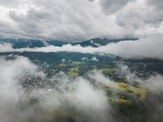 Aerial drone photo through the clouds in Zakopane, a resort town in southern Poland at the foot of the Tatra Mountains.