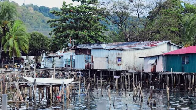 Fishing village houses over the water garbage poor areas in Sabah province in Malaysia