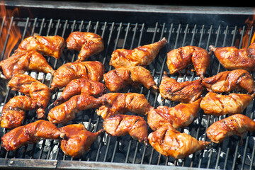 Spicy Marinated Chicken legs grilling on a summer barbecue . - 746499608