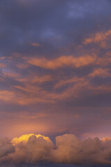 evening sky at sunset with yellow and purple cumulus and perispheric clouds