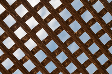 Texture of old wooden gate in metal frame. Background