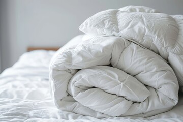 White several folded duvets lying on white bed background. Preparing for winter season, hotel or home textile, Generative AI