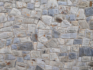 Textura de un muro de piedras irregulares grises