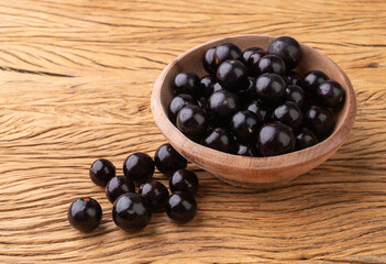 Jabuticabas on a bowl over wooden table