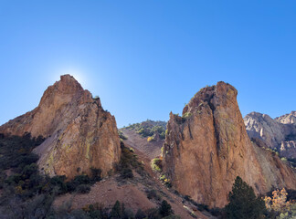 Two large sandstone mountain rocks hiding the desert sun in Texas, clear blue sky. Hot scorching environment.
