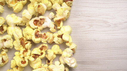 Caramel Popcorn is isolated on wooden background. Salted popcorn on the wooden table.