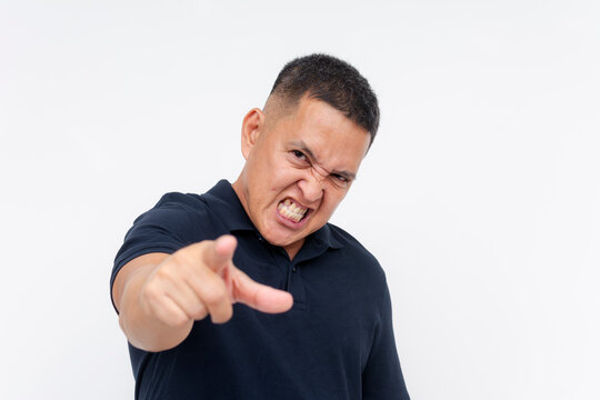 A resentful middle aged man snarling and blaming someone for his failures. Isolated on a white background.