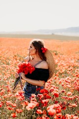 Woman poppies field. portrait happy woman with long hair in a poppy field and enjoying the beauty of nature in a warm summer day.