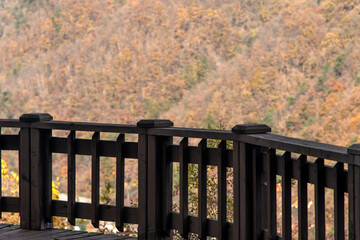 View of the autumn mountain over the wooden fence