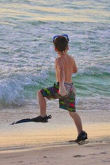 Young Boy in Flippers Walking into the Water at a Florida Beach