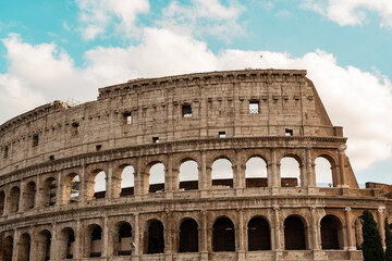 Naklejka premium detail of the colosseum on a sunny day with clouds