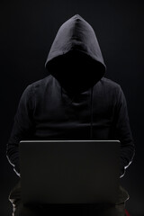 a shady figure that could represent a criminal, a hacker, ambiguity and duplicity