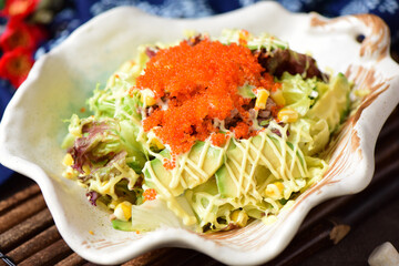Delicious crab, tuna, fruit and vegetable salad on a plate