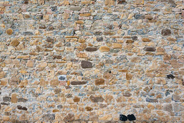 Stone wall background and ancient tuff, Tuscany in Italy
