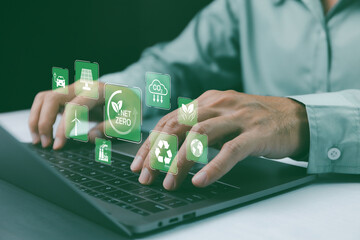 Net-zero and carbon-neutral concept. Person use laptop showcasing eco-friendly icons including 