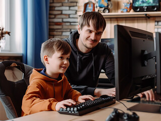 Father and son play a game on the computer in a cozy home environment