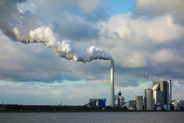 Power station with smoking chimney. Electric plant, turbine generator in the power plant