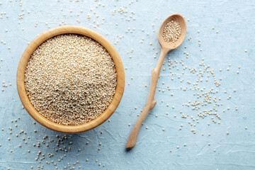 Quinoa in a bowl, healthy organic wood, uncooked, with a wooden spoon and a place for text - 746538405