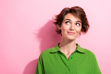 Photo of dreamy excited lady wear green shirt looking empty space isolated pink color background