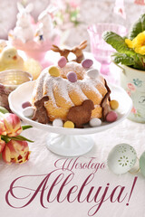 Easter greeting card with traditional ring cake on festive table with inscription in Polish language translated as Happy Easter