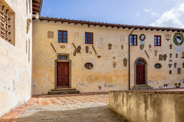 Ancient noble coats of arms adorn a wall in the Vicari castle, Lari, Pisa, Italy