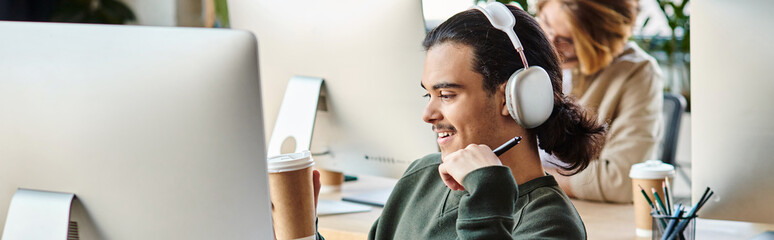 cheerful male professional in headphones holding coffee to go and working on project, banner