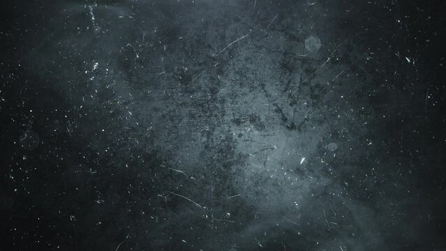 Smoke, dust, and particle motion video against a dark grey background
