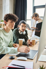 post production retouching professionals discussing project on monitor in modern office, men in 20s