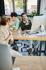 Creative team focused on post-production work while looking at monitor in office, men in 20s