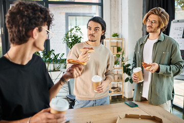 doubtful men eating pizza in a relaxed office atmosphere, young startup team having lunch break
