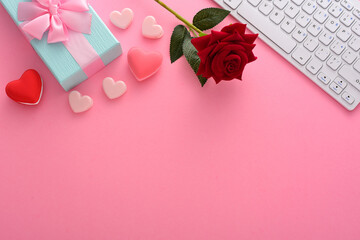 Gift box with love rose and Computer keyboard on pink white background