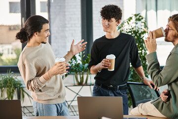 friendly conversation between three young coworkers holding coffee to go in modern office, startup - 746548454
