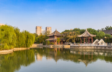 Renmin Peoples pakk with buildings and bridge in Tianjin, China