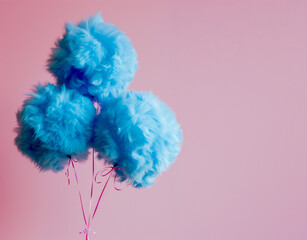 Creative concept of blue fur balloons isolated on pink background. Minimal pastel party concept. Copy space. Banner