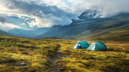 Two Tents pitched up in the Highlands. Camping / Active Lifestyle Concept with Dramatic Mountain Scenery.