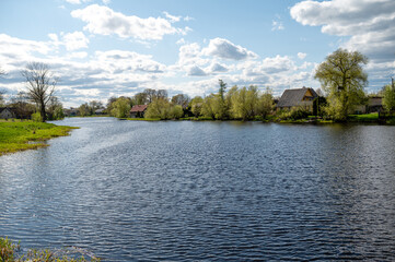 Scenic view of the river and village in spring.