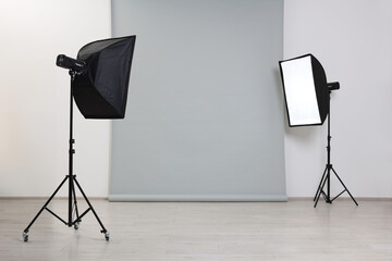 Modern light grey photo background and softboxes in studio