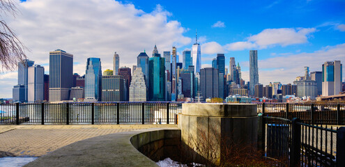 New York City Lower Manhattan Skyline and skyscrapers over the curving footpath at Brooklyn Heights...