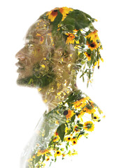 A double exposure profile portrait of a man combined with yellow flowers