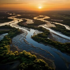 an aerial view of a river at sunset